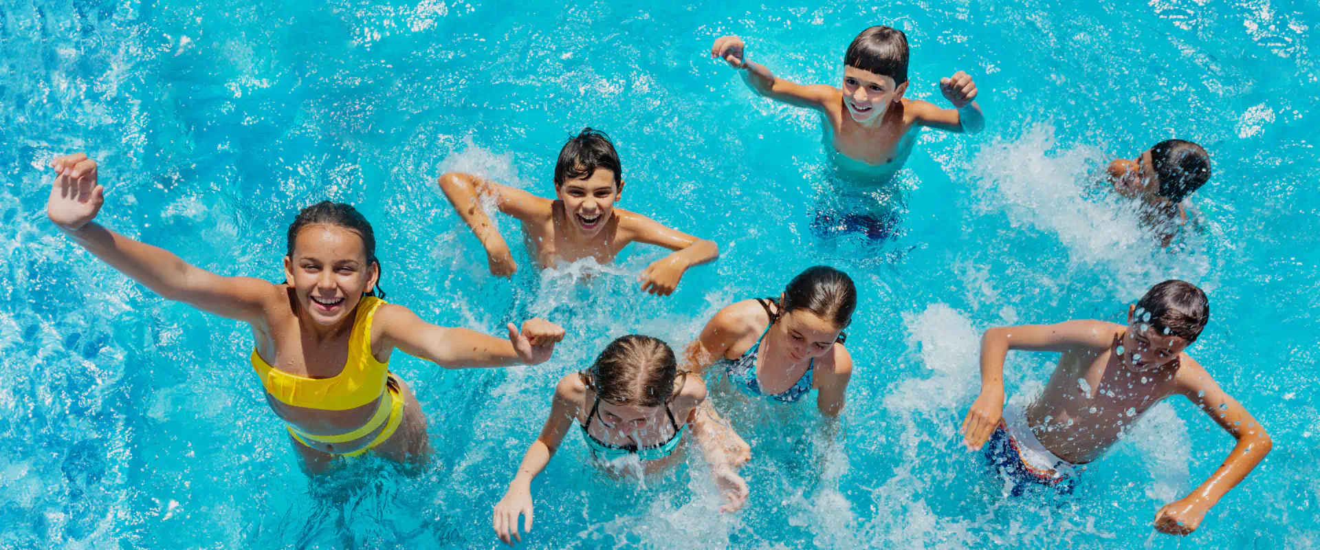 childrens enjoying pool at bright morning